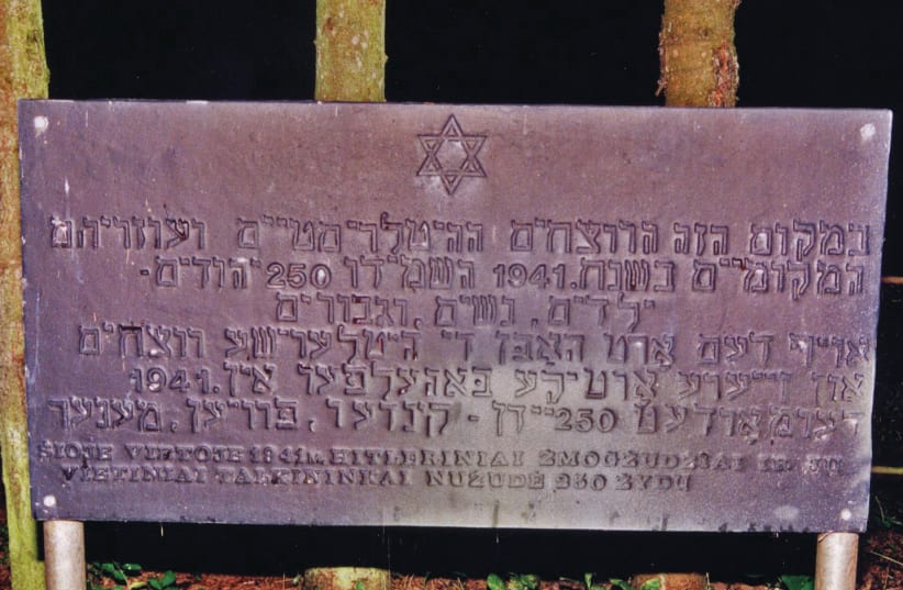 A sign in Yiddish, Hebrew and Lithuanian saying,‘In this place the Hitlerist murderers and their local helpers in the year of 1941 murdered 250 Jews, children, women and men’ (photo credit: COURTESY OF BARRY MANN)