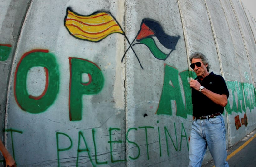 FILE PHOTO: British rock star Roger Waters walks along the Israeli barrier in the West Bank city of Bethlehem (photo credit: REUTERS/AHMAD MEZHIR/FILE PHOTO)