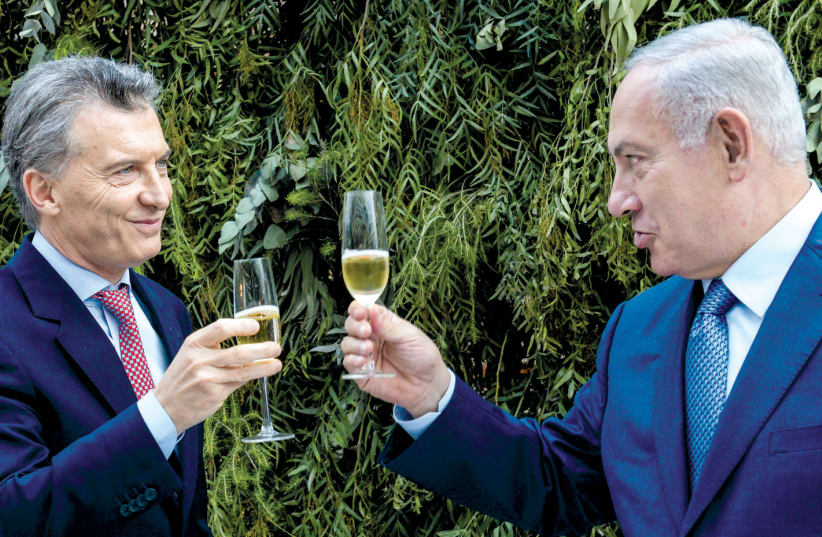 PRIME MINISTER Benjamin Netanyahu and Argentina’s President Mauricio Macri make a toast during lunch at the Casa Rosada Presidential Palace in Buenos Aires in September (photo credit: REUTERS)