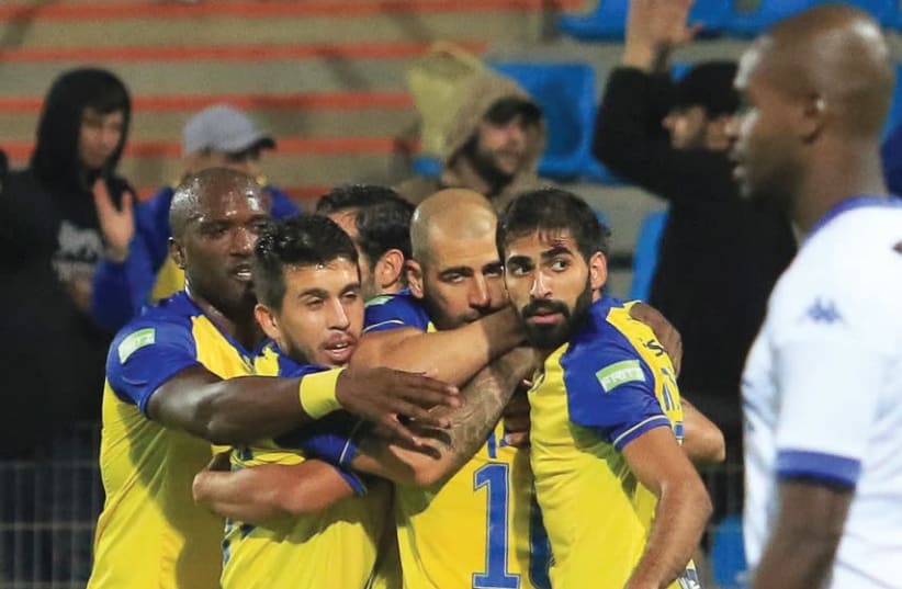 Maccabi Tel Aviv players celebrate after sealing a 2-0 win over Ironi Kiryat Shmona in the Toto Cup semifinals in Acre (photo credit: ERAN LUF)