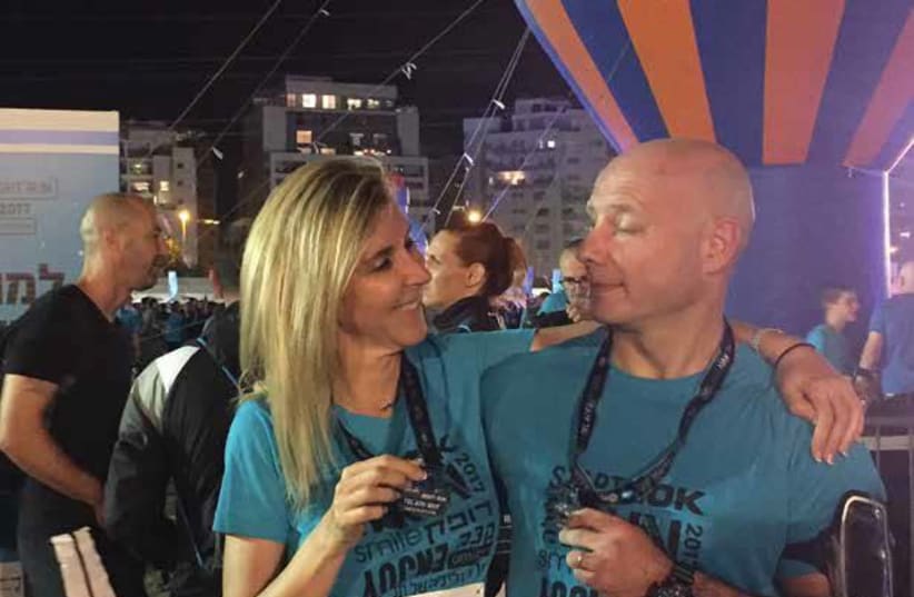 Sara Omer and her friend Stewart Taylor after they completed the 10K TLV Night Run in October (photo credit: Courtesy)