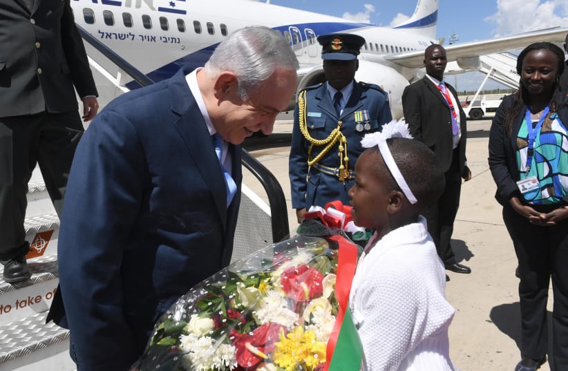 PRIME MINISTER Benjamin Netanyahu gets a warm welcome at the airport in Nairobi, where he flew this past week to attend the re-inauguration of Kenya’s President Uhuru Kenyatta.  (photo credit: CHAIM TZACH/GPO)