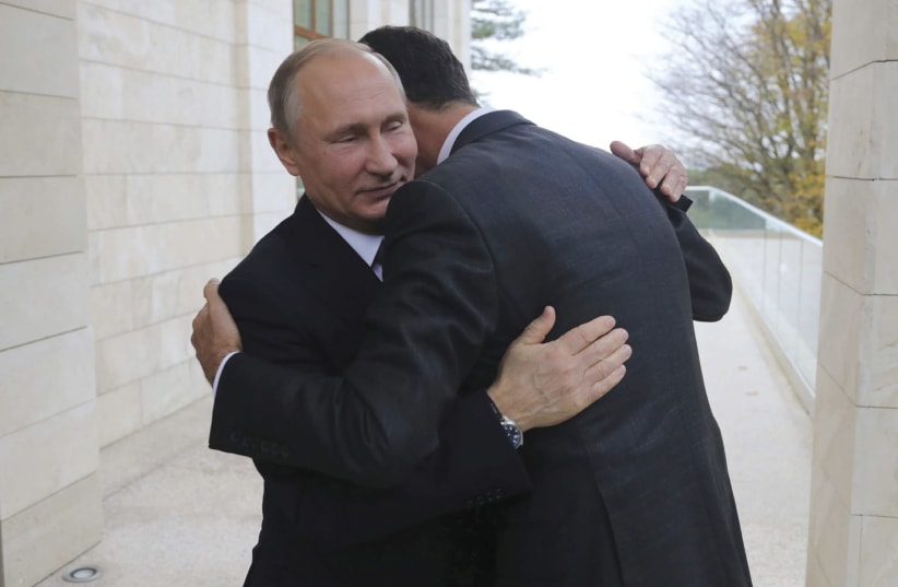 Russian President Vladimir Putin welcomes Syrian President Bashar Assad in the Black Sea resort of Sochi this month (photo credit: SPUTNIK/MIKHAIL KLIMENTYEV/KREMLIN VIA REUTERS)