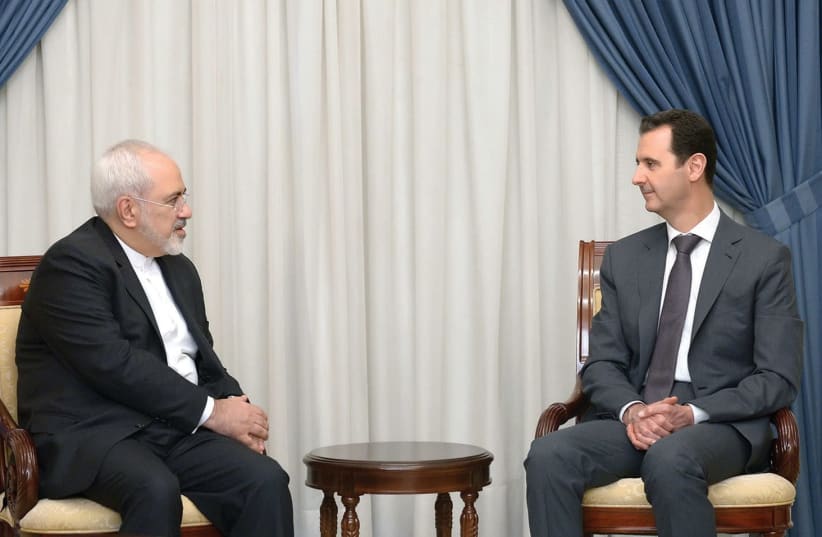 SYRIAN PRESIDENT Bashar Assad meeting with Iranian foreign minister Javad Zarif in 2015. (photo credit: REUTERS)