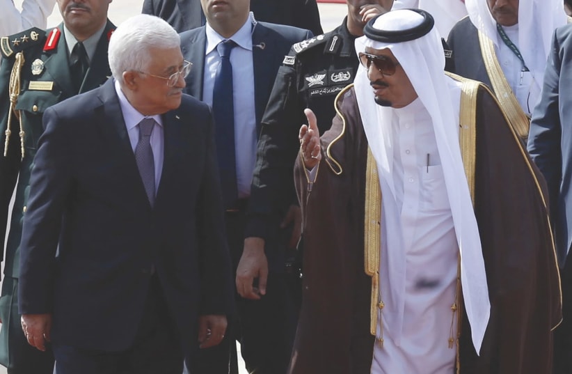 Saudi Arabia's King Salman bin Abdulaziz Al Saud walks with Palestinian President Mahmoud Abbas during a reception ceremony in Riyadh in 2015. (photo credit: REUTERS/FAISAL AL NASSER)