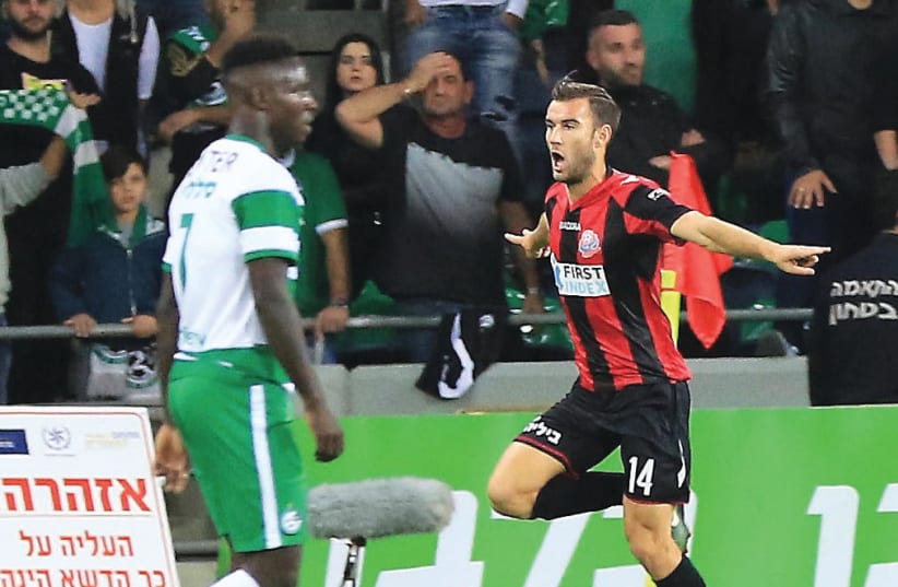 Hapoel Haifa returned to first place in the Premier League standings with the sweetest possible victory on Monday, defeating Maccabi Haifa 1-0 in the derby. (photo credit: ERAN LUF)