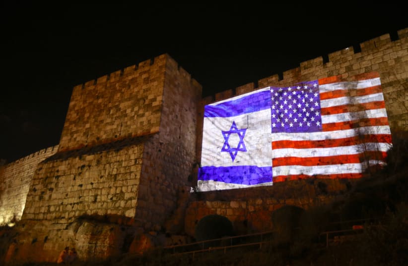 US and Israeli flags beaming onto Jerusalem wall side-by-side (photo credit: MARC ISRAEL SELLEM/THE JERUSALEM POST)