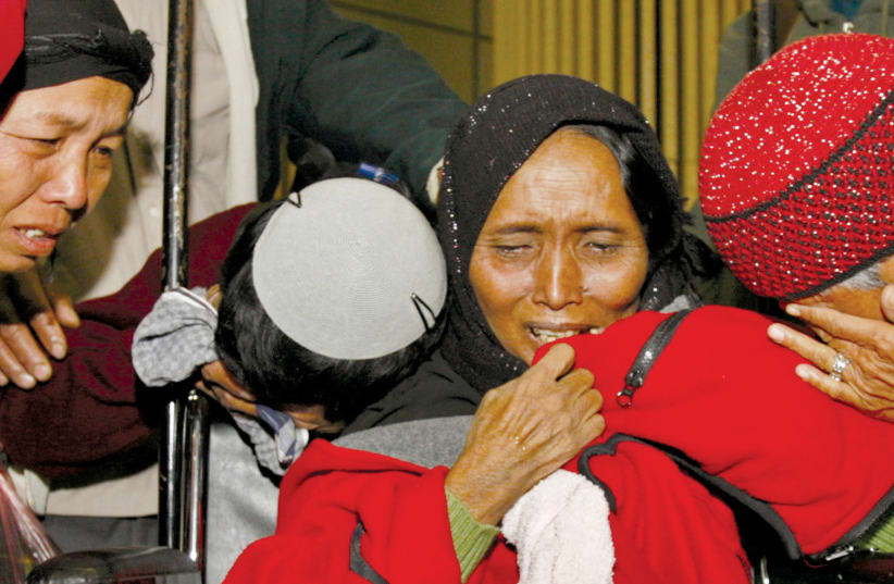 NEWLY ARRIVED Jewish immigrants from India cry upon arrival at Ben-Gurion Airport in 2006. The immigrants are members of the Bnei Menashe community from India’s remote northeastern states of Mizoram and Manipur (photo credit: REUTERS/GIL COHEN MAGEN)