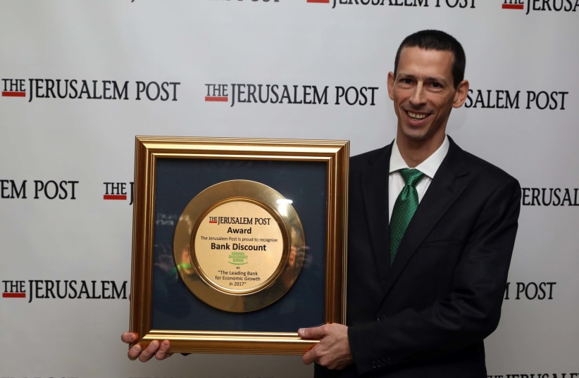 DISCOUNT BANK CFO and head of strategy, Ziv Biron, is given the The Jerusalem Post award for the organization's success in fostering economic growth. (photo credit: SIVAN FARAJ)