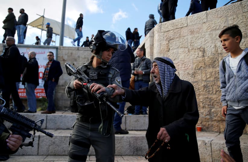 A Palestinian man argues with an Israeli border policewoman during a protest following US President Donald Trump's announcement that he has recognized Jerusalem as Israel's capital, near Damascus Gate in Jerusalem's Old City December 7, 2017. (photo credit: REUTERS/AMMAR AWAD)