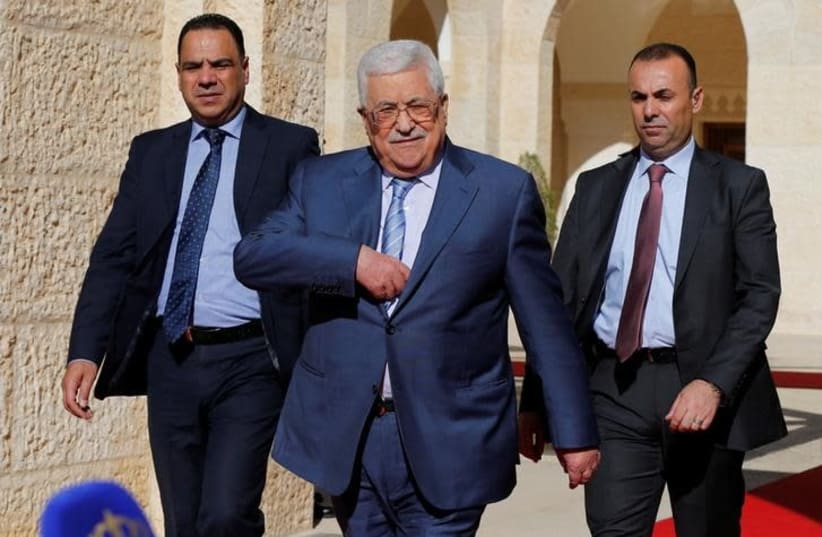 Palestinian Authority President Mahmoud Abbas walks to speaks to the media after his meeting with Jordan's King Abdullah at the Royal Palace in Amman, Jordan October 22, 2017 (photo credit: REUTERS/MUHAMMAD HAMED)