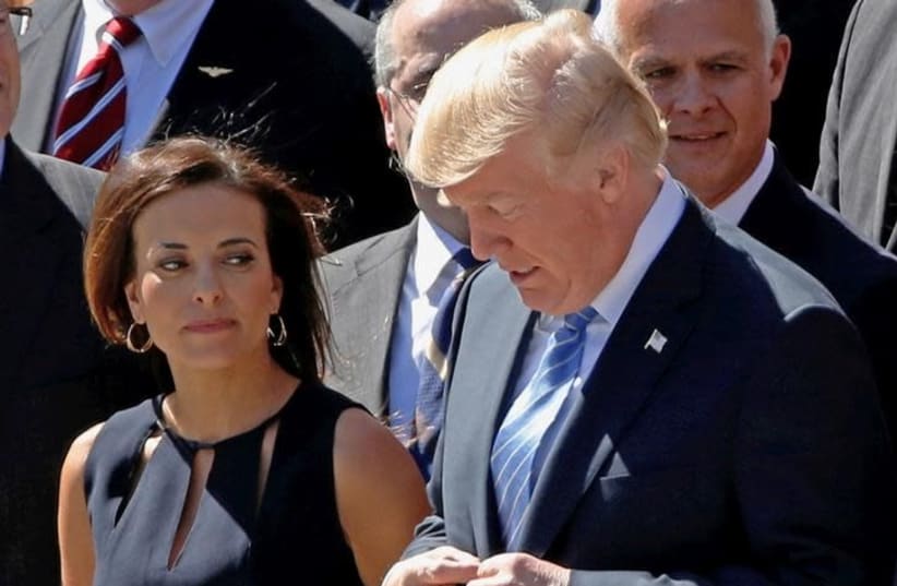 US President Donald Trump, flanked by Deputy National Security Advisor for Strategy Dina Powell (L) poses for a picture with his National Security team to mark the 70th anniversary of the National Security Council, at the White House in Washington, US September 28, 2017 (photo credit: REUTERS/JONATHAN ERNST)