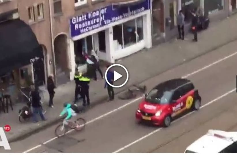 Screenshot of AT5 site with video of Palestinian man attacking Kosher resturant in Amsterdam (photo credit: screenshot)