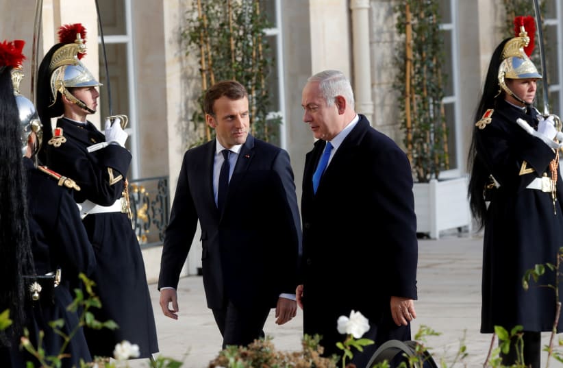 French President Emmanuel Macron welcomes Israeli Prime Minister Benjamin Netanyahu in Paris (photo credit: PHILIPPE WOJAZER / REUTERS)