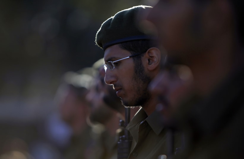 An Israeli soldier of the Ultra-Orthodox brigade takes part in a swearing-in ceremony in Jerusalem. (photo credit: REUTERS)
