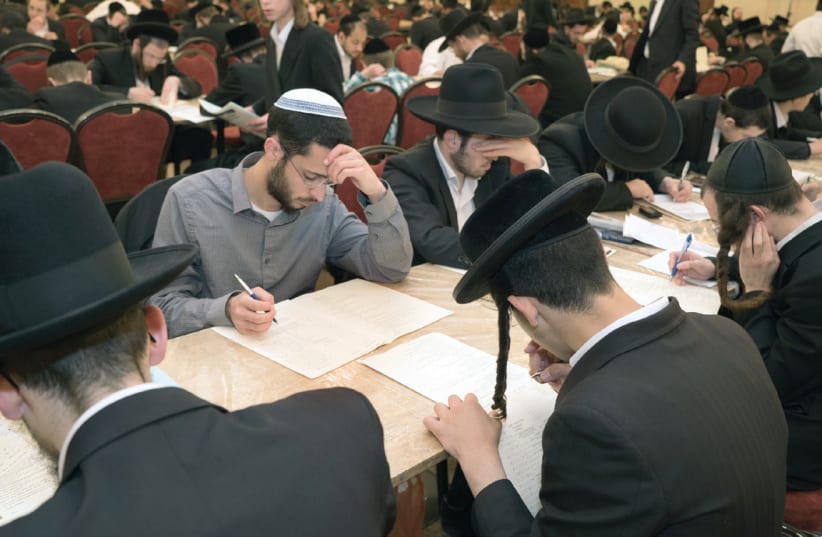 A typical scene at a Dirshu testing site, where Jews, young and old, and from all backgrounds, gather each month in dozens of locations worldwide (photo credit: DIRSHU)
