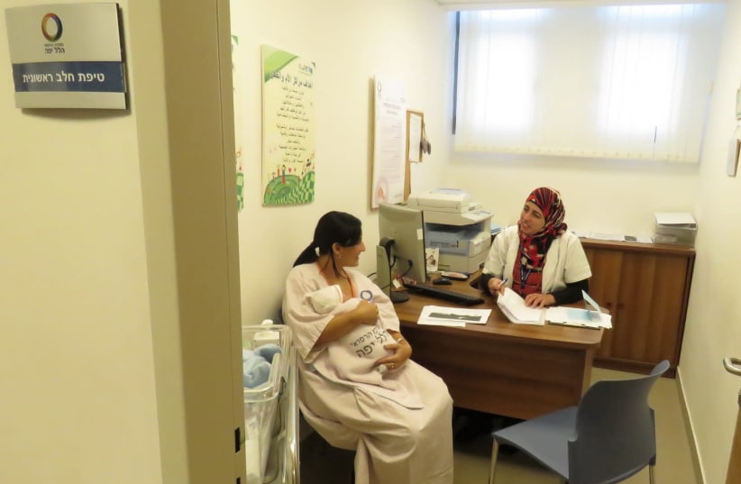 Tipat halav nurse Linda Kaadan and new mother Dana Bar (photo credit: HILLEL YAFFE MEDICAL CENTER)
