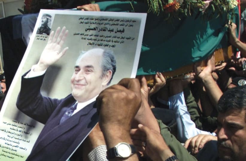 PLO OFFICIALS carry the coffin of Palestinian minister for Jerusalem, Faisel al-Husseini, in 2001 on his way to the West Bank at Amman airport.  (photo credit: REUTERS)
