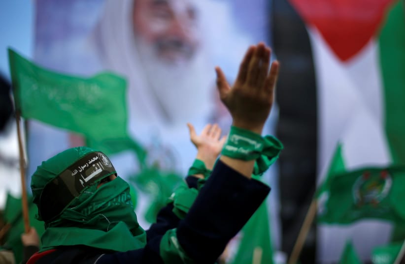 A Palestinian woman supporting Hamas takes part in a rally marking the 30th anniversary of Hamas' founding, in Gaza City December 14, 2017 (photo credit: SUHAIB SALEM / REUTERS)