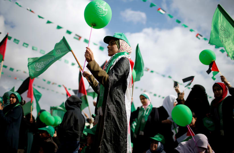 Palestinians supporting Hamas take part in a rally marking the 30th anniversary of Hamas' founding, in Gaza City December 14, 2017 (photo credit: MOHAMMED SALEM/REUTERS)