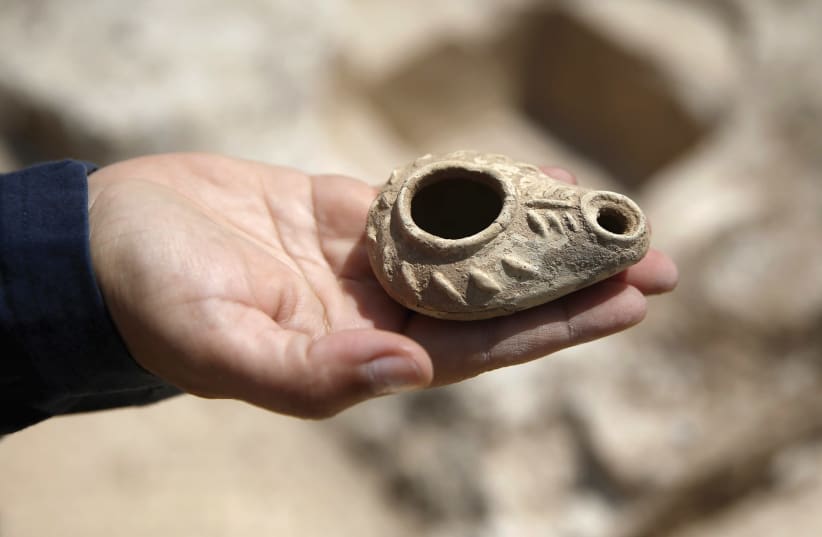 AN ANCIENT oil lamp unearthed at a site dating back 1,500 years and frequented by travelers between Jerusalem and the Coastal Plain, was exposed, near Beit Nekofa, west of Jerusalem, in 2015.  (photo credit: REUTERS)