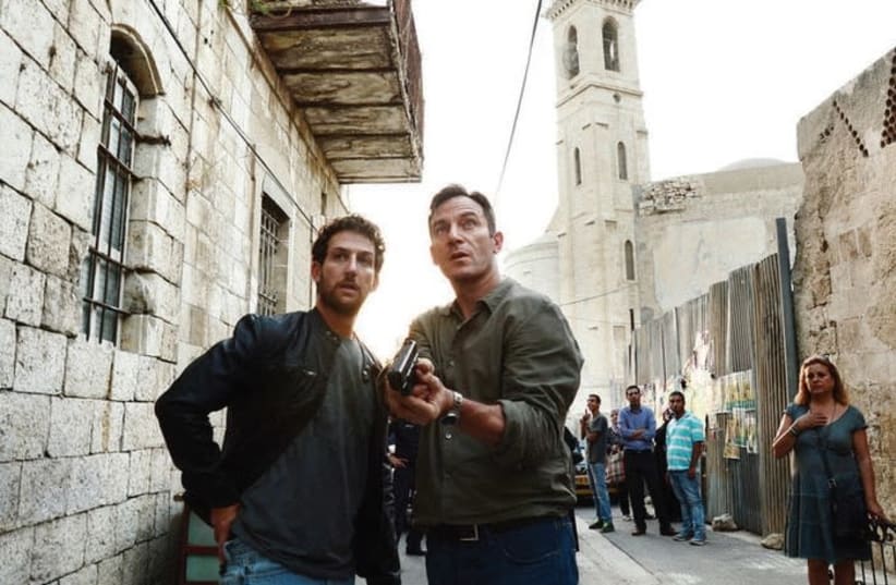 JASON ISAACS (right) and Ori Pfeffer on the set of the US TV show ‘Dig.’  The show, produced by NBCUniversal for its USA Network, stopped filming in Israel during the June 2014 Gaza war and completed filming in Croatia and New Mexico.  (photo credit: RONEN AKERMAN/USA NETWORK)