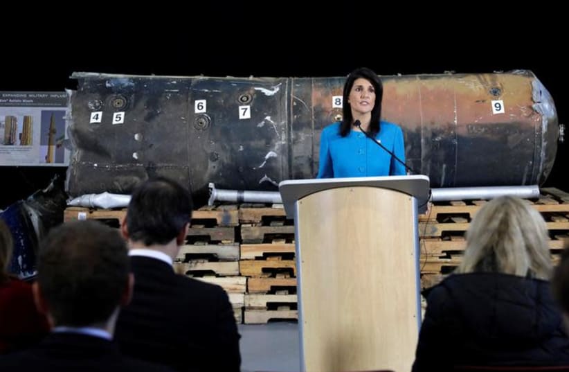 US Ambassador to the United Nations Nikki Haley briefs the media in front of remains of Iranian "Qiam" ballistic missile provided by Pentagon at Joint Base Anacostia-Bolling in Washington, US, December 14, 2017. (photo credit: YURI GRIPAS/REUTERS)