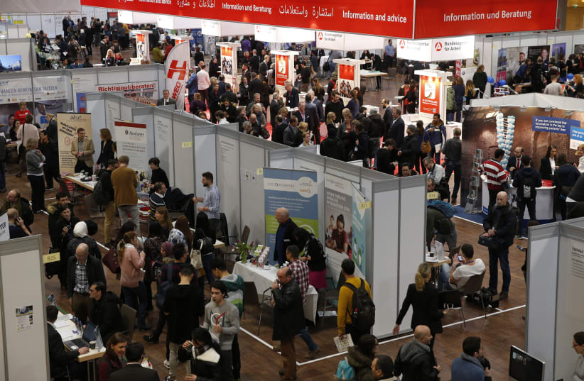 People visit the second job fair for migrants and refugees in Berlin, Germany. (photo credit: REUTERS)
