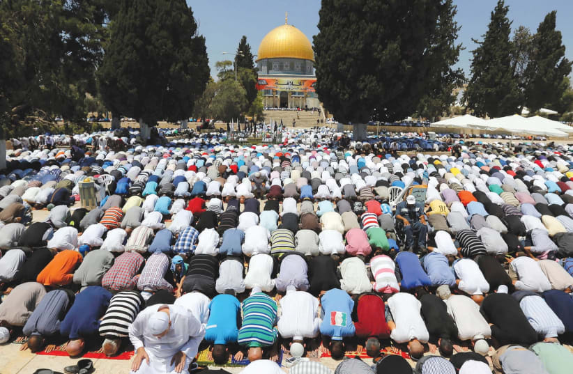 MUSLIMS PRAY next to Al-Aqsa Mosque in Jerusalem. (photo credit: REUTERS)