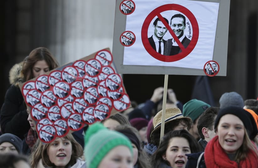 Protesters hold banners showing portraits of new Austrian Chancellor Sebastian Kurz of the People's Party (OeVP) and Vice Chancellor Heinz-Christian Strache of the Freedom party (FPOe) (photo credit: REUTERS/HEINZ-PETER BADER)