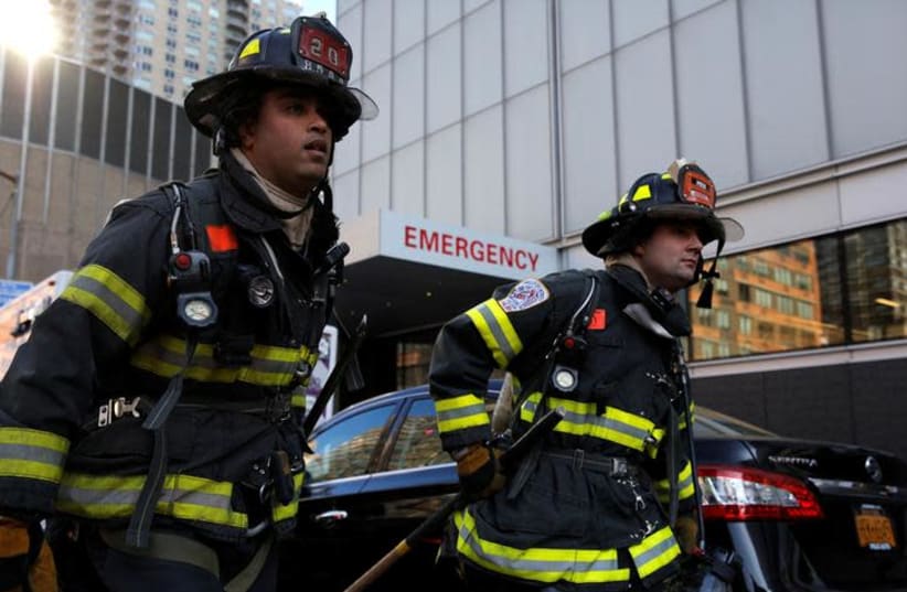New York City firefighters (FDNY) at the scene of a fire at NYU Medical Center in Manhattan, New York City, U.S., December 14, 2016.  (photo credit: BRENDAN MCDERMID/REUTERS)