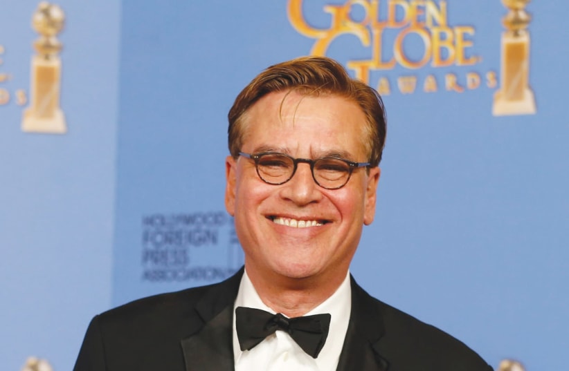 AARON SORKIN poses with the award for Best Screenplay - Motion Picture for ‘Steve Jobs’ last year. (photo credit: REUTERS)