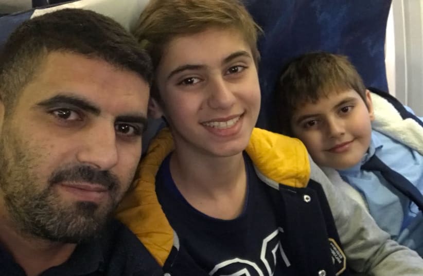 Jamil Abu Jama and his children as they landed at Ben Gurion Airport  (photo credit: Courtesy)