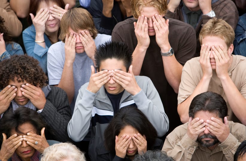 A crowd of people covering their eyes. (illustrative) (photo credit: INGIMAGE)