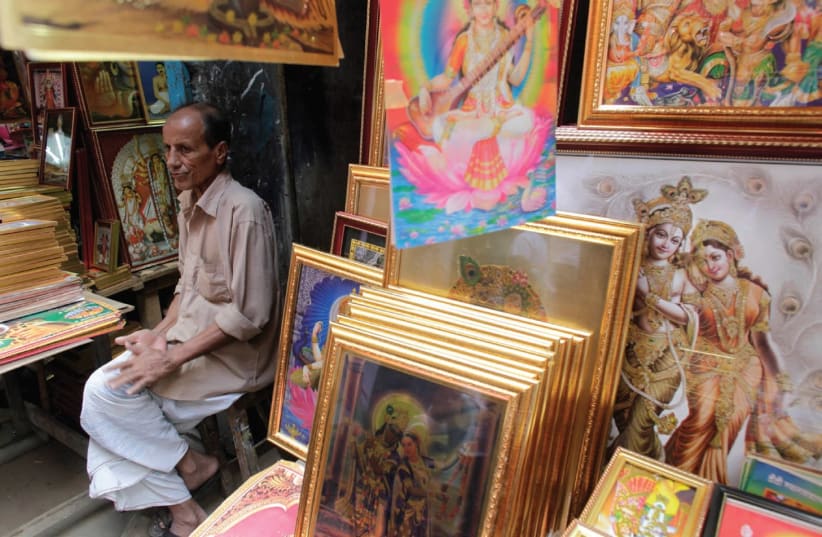  A VENDOR sells pictures of Hindu goddess during Durga Puja in old Dhaka. (photo credit: REUTERS)