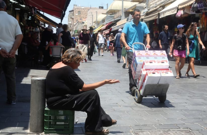 A woman begs in Jerusalem (photo credit: MARC ISRAEL SELLEM/THE JERUSALEM POST)