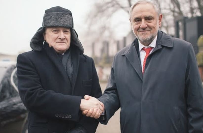 Polish deputy Prime Minister Piotr Glinski (left) meets with World Jewish Congress CEO and executive vice president Robert Singer at the Warsaw Cemetery on Monday (photo credit: WORLD JEWISH CONGRESS)
