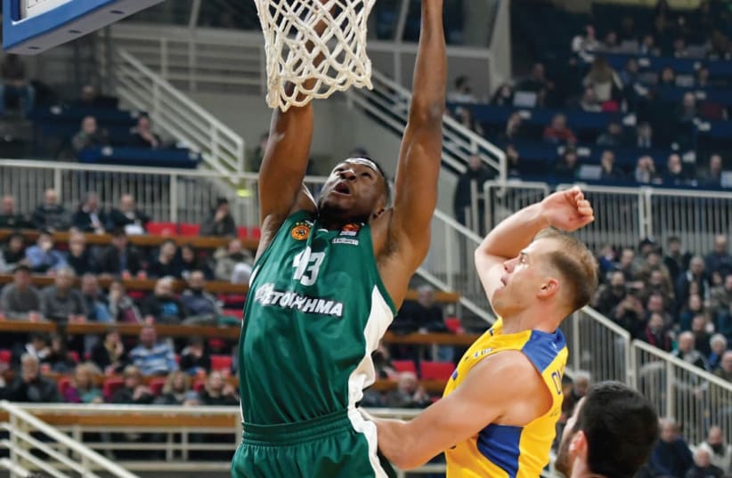 Panathinaikos forward Thanasis Antetokounmpo goes up for a dunk against Maccabi Tel Aviv guard Michael Roll during last night’s win for the Greeks in Athens (photo credit: UDI ZITIAT)