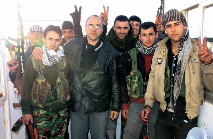 Jonathan Spyer (in the black leather jacket) with fighters of the Kurdish YPG in Sereh Kaniyeh, Syria, in 2013 (photo credit: Courtesy)