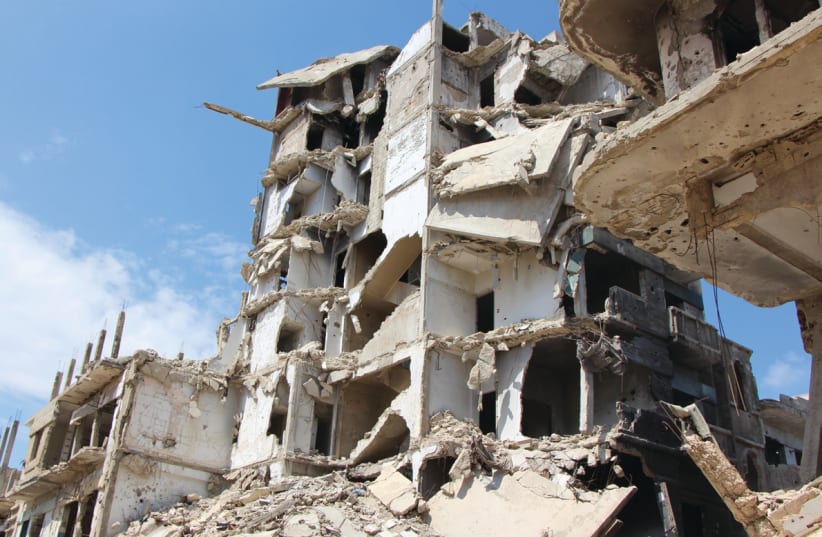 A BOMBED-OUT neighborhood of Homs, Syria, earlier this year (photo credit: Courtesy)