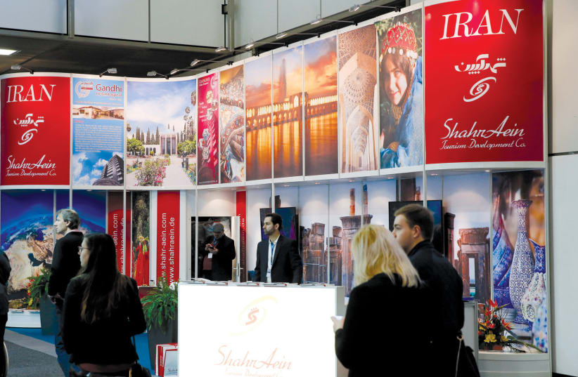 VISITORS BROWSE the exhibition stand of Iran at the International Tourism Trade Fair in Berlin last year. (photo credit: REUTERS/FABRIZIO BENSCH)