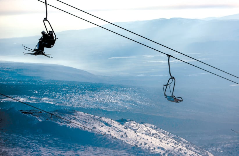 SKIERS RIDE a ski lift on Mount Hermon in the Golan Heights (photo credit: REUTERS/NIR ELIAS)