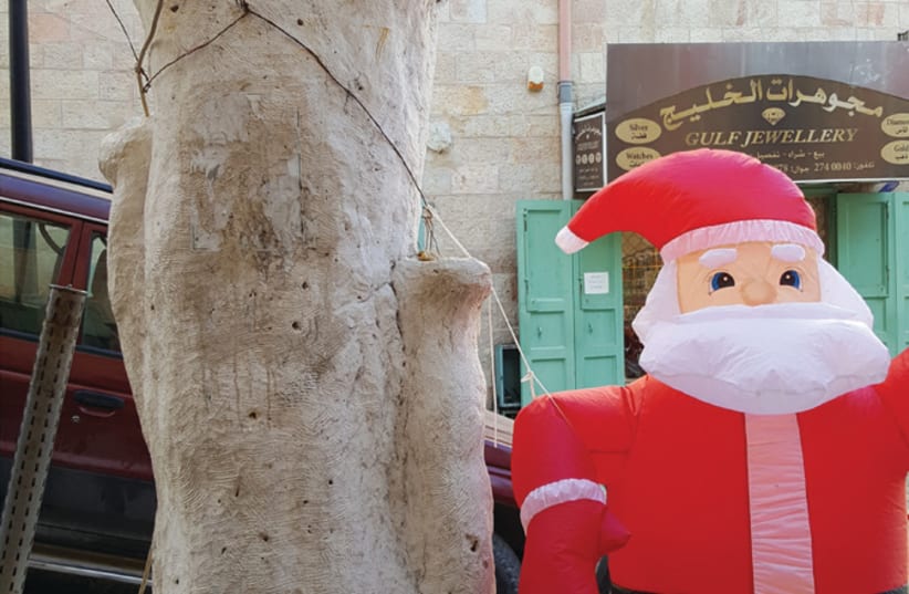 Archeology on display next to a Santa balloon in Bethlehem (photo credit: BEN BRESKY)