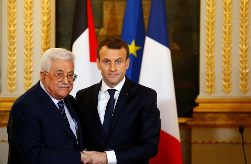 French President Emmanuel Macron (R) and Palestinian President Mahmoud Abbas deliver a press statement after a meeting at the Elysee Palace in Paris, France, December 22, 2017. (photo credit: REUTERS)