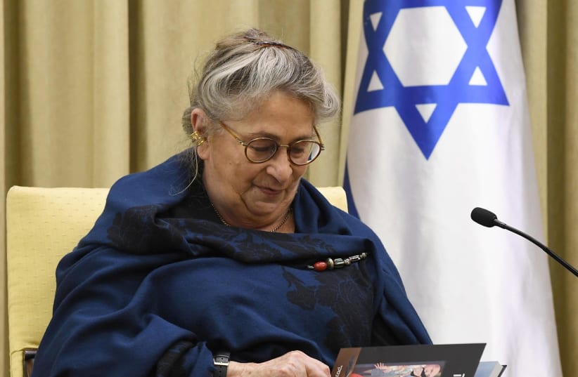 Nechama Rivlin looking through a graphic novel based on The Diary of Anne Frank. (photo credit: Mark Neiman/GPO)