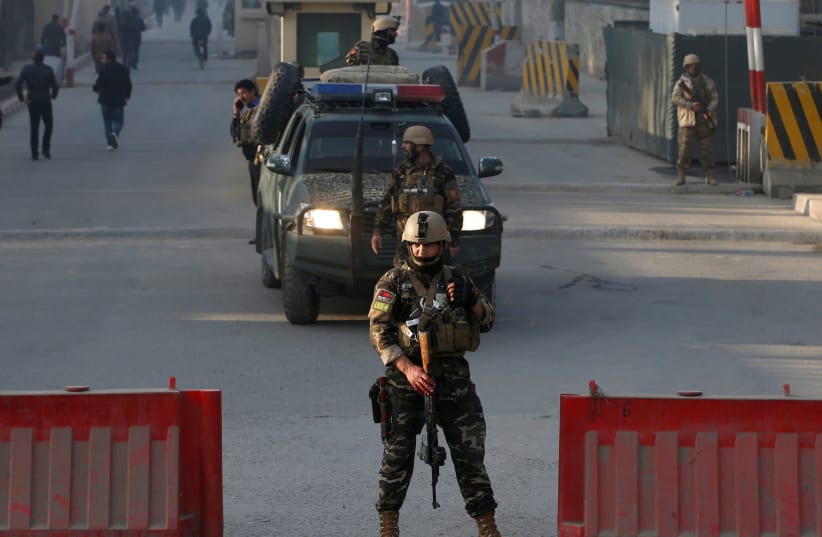 Afghan security forces keep watch at a check point close to the compound of Afghanistan's national intelligence agency in Kabul, Afghanistan. (photo credit: REUTERS/OMAR SOBHANI)