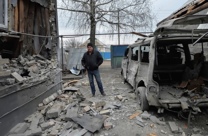 A MAN inspects his house, which was damaged by recent shelling, in the government-held village of Novoluhanske, Ukraine. (photo credit: REUTERS)
