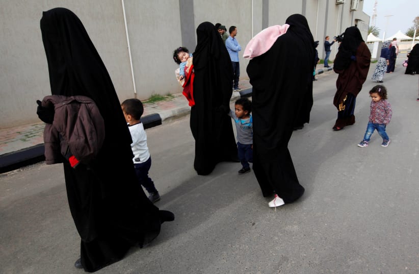 Female jihadists walk with their children at Reform and Rehabilitation foundation in Mitiga in Tripoli, Libya. (photo credit: REUTERS)