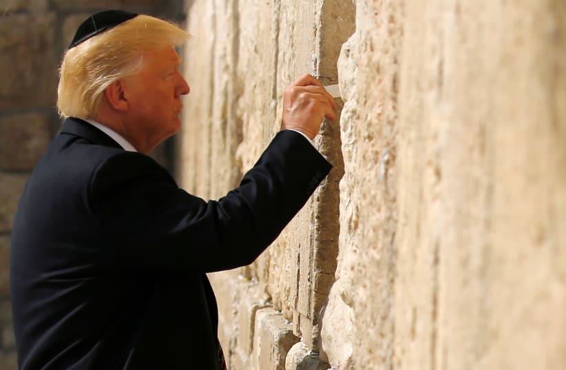 US President Donald Trump leaves a note at the Western Wall, Judaism's holiest prayer site, in Jerusalem's Old City May 22, 2017 (photo credit: RONEN ZVULUN / REUTERS)