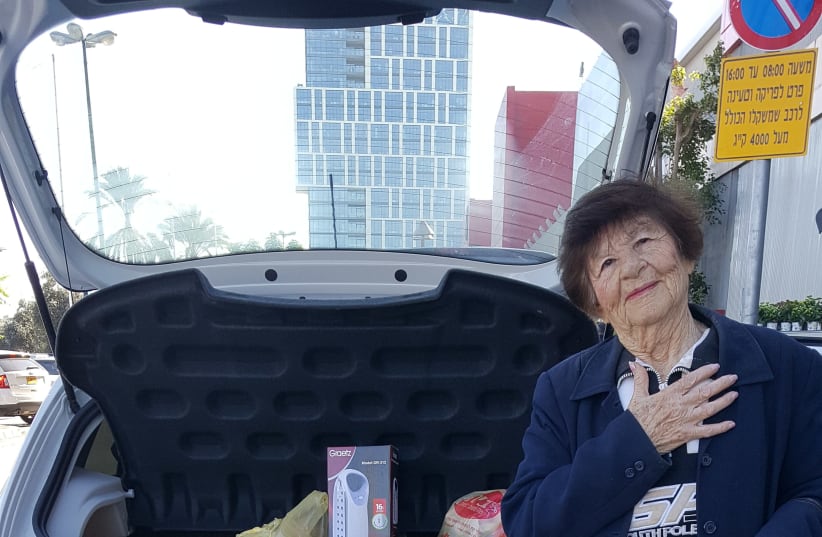 Alexandra, a Holocaust survivor, with groceries purchased for her by the Association for the Immediate Help for Holocaust Survivors (photo credit: THE ASSOCIATION FOR IMMEDIATE HELP FOR HOLOCAUST SURVIVORS)